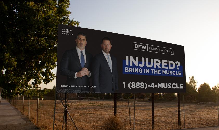 DFW Injury Lawyers billboard on rural street
