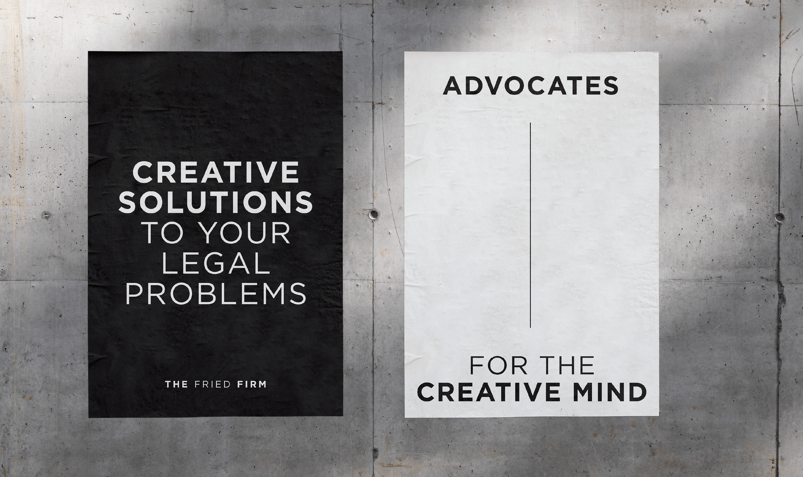 Two posters side by side on a concrete wall. The left poster has a black background with bold white text that reads: 