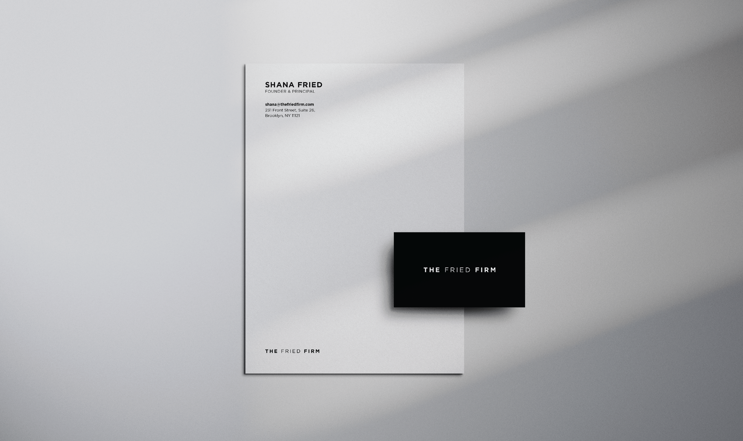 Minimalist letterhead and business card for The Fried Firm. The letterhead lists Shana Fried’s contact info; the card reads “THE FRIED FIRM” with “THE” and “FIRM” in bold.