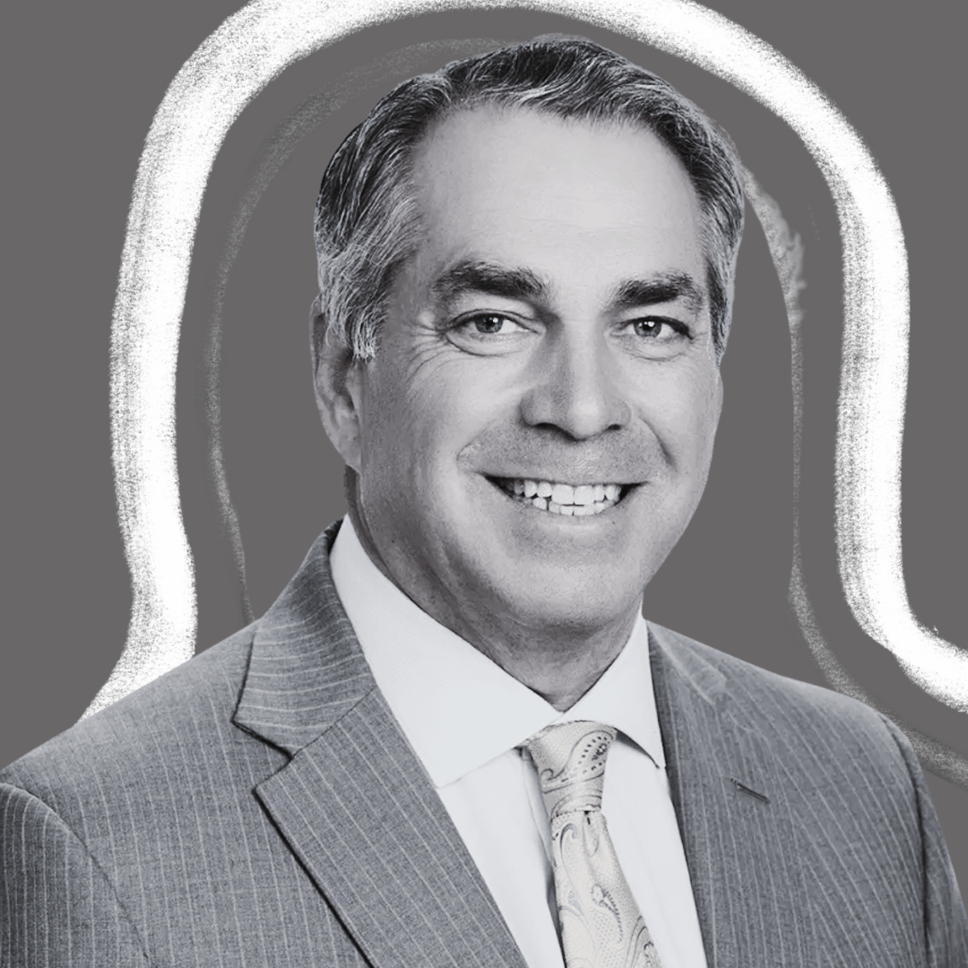 A man in a pinstripe suit and patterned tie smiles at the camera. The image is black and white with a gray background featuring a white abstract outline around him.
