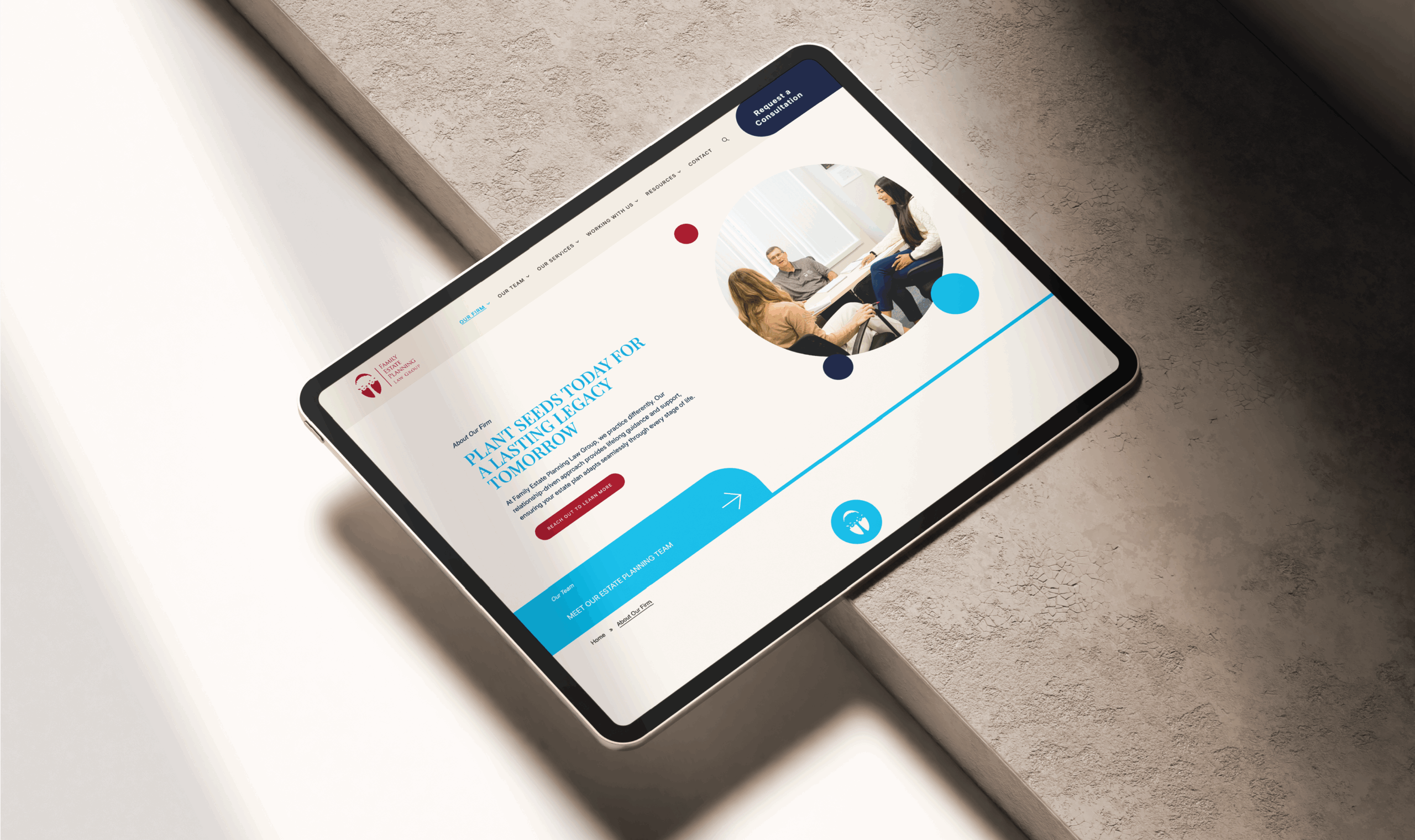 A tablet displaying the new FEPLG website with a professional design is shown on a stone surface. Visible elements include text and an image of a group discussion.