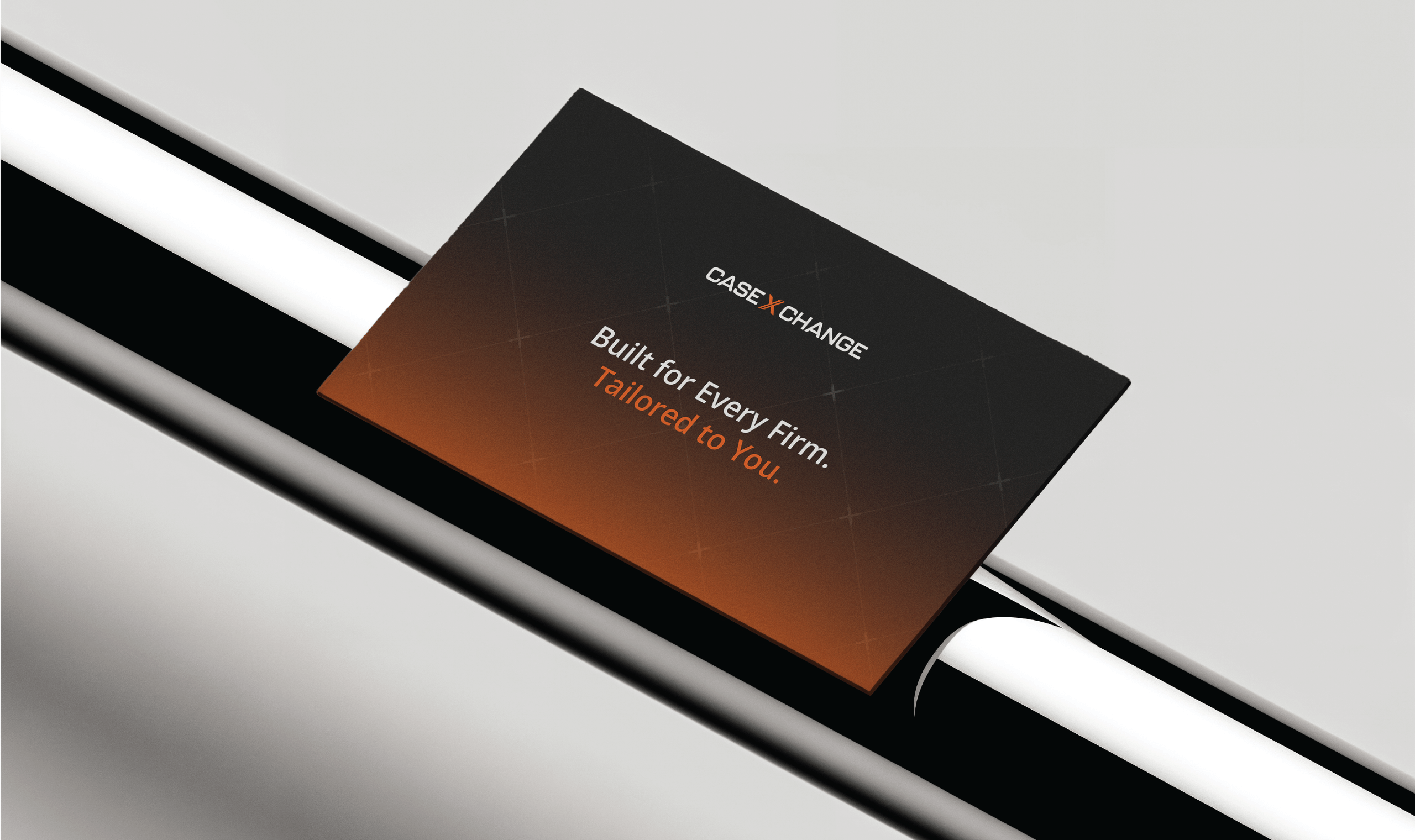Rectangular Case Xchange promotional card resting on a sleek black and white metallic surface. The card features a dark-to-orange gradient background with the Case Xchange logo at the top and the tagline “Built for Every Firm. Tailored to You.” in white and orange text.