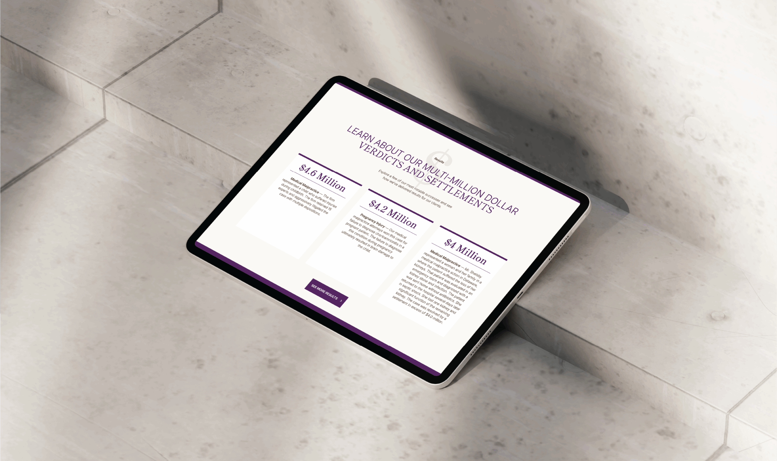 A tablet rests on marble steps, displaying Shelsby & Leoni's new website, featuring information about multi-million dollar verdicts and settlements. The screen shows text boxes with monetary amounts.